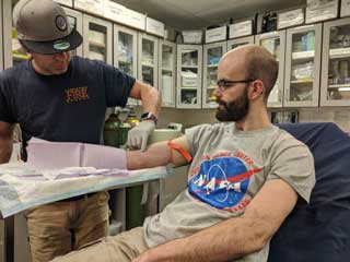 drawing blood for a NASA science study