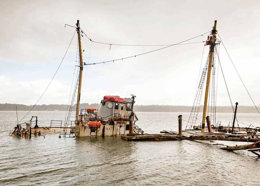 an undated 2018 Chinook Observer file photo of the sunken Hero at high tide