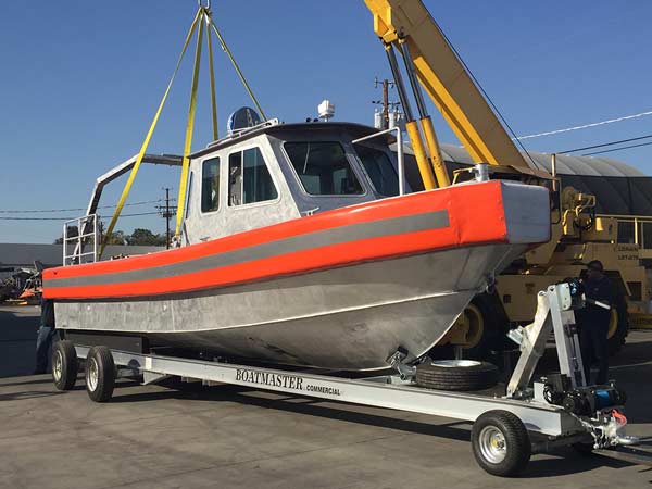 the first boat being lowered onto its trailer