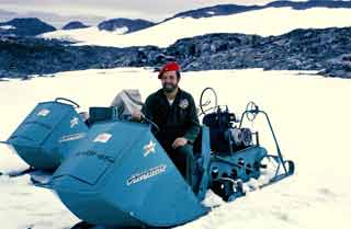 a snow traveler Jack posing on one of the station snowmobiles